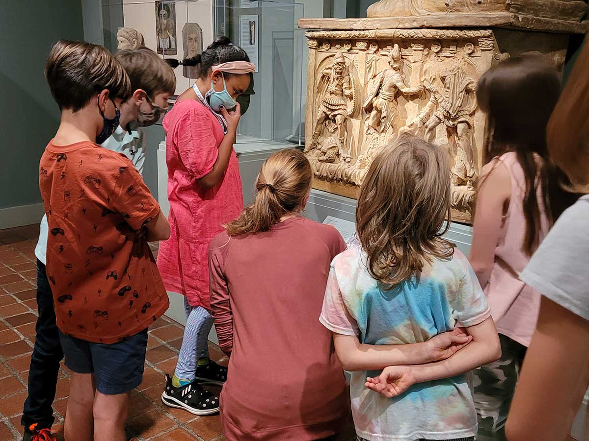 A group of students explore a gallery with an educator