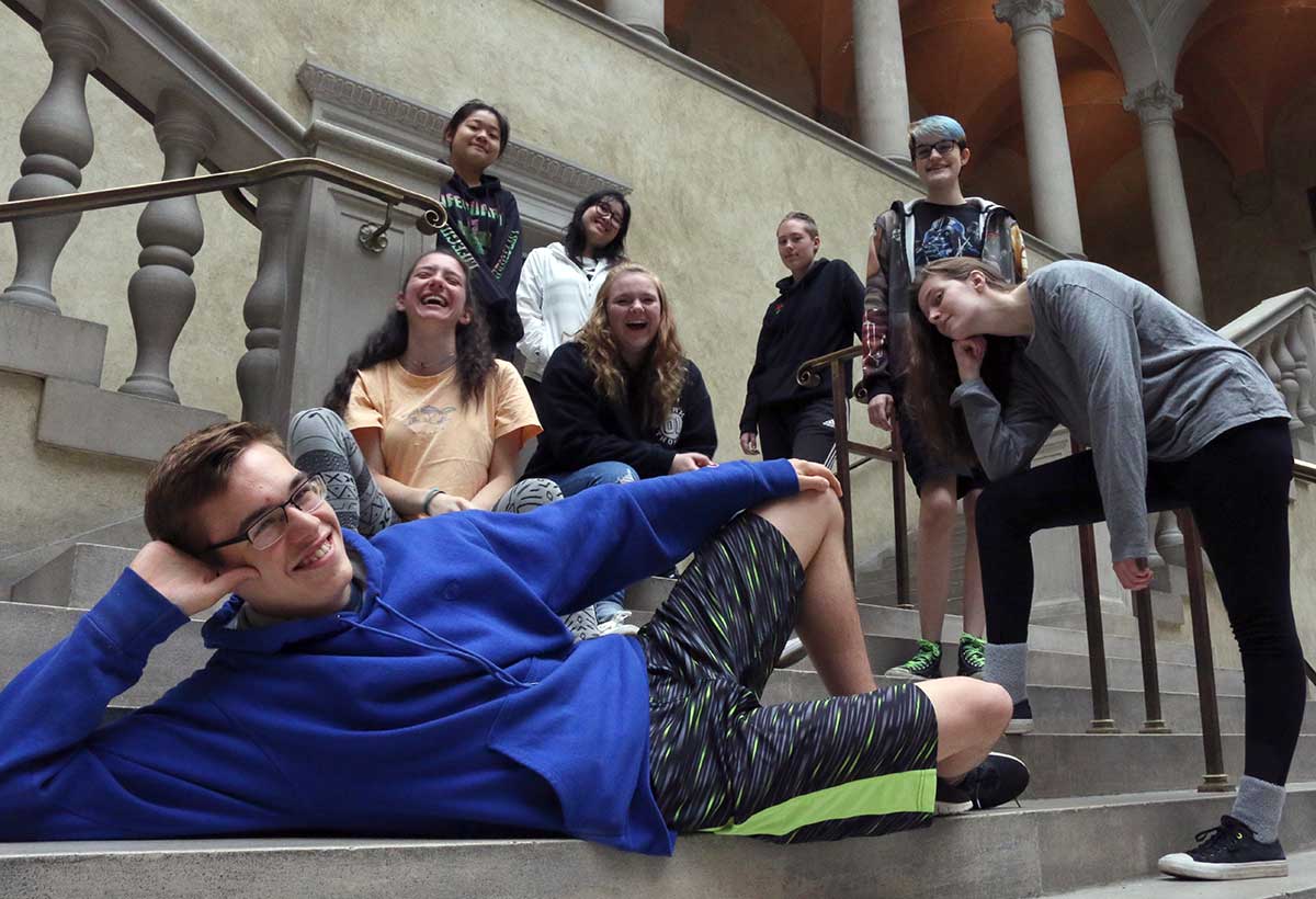 A group of happy teenagers pose on the Renaissance Court steps at WAM